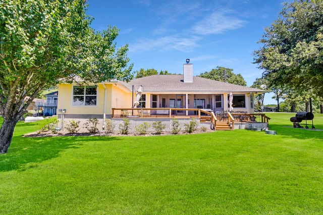 a front view of a house with a yard table and chairs