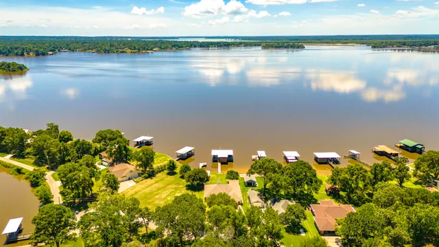 a view of back yard with outdoor seating and lake
