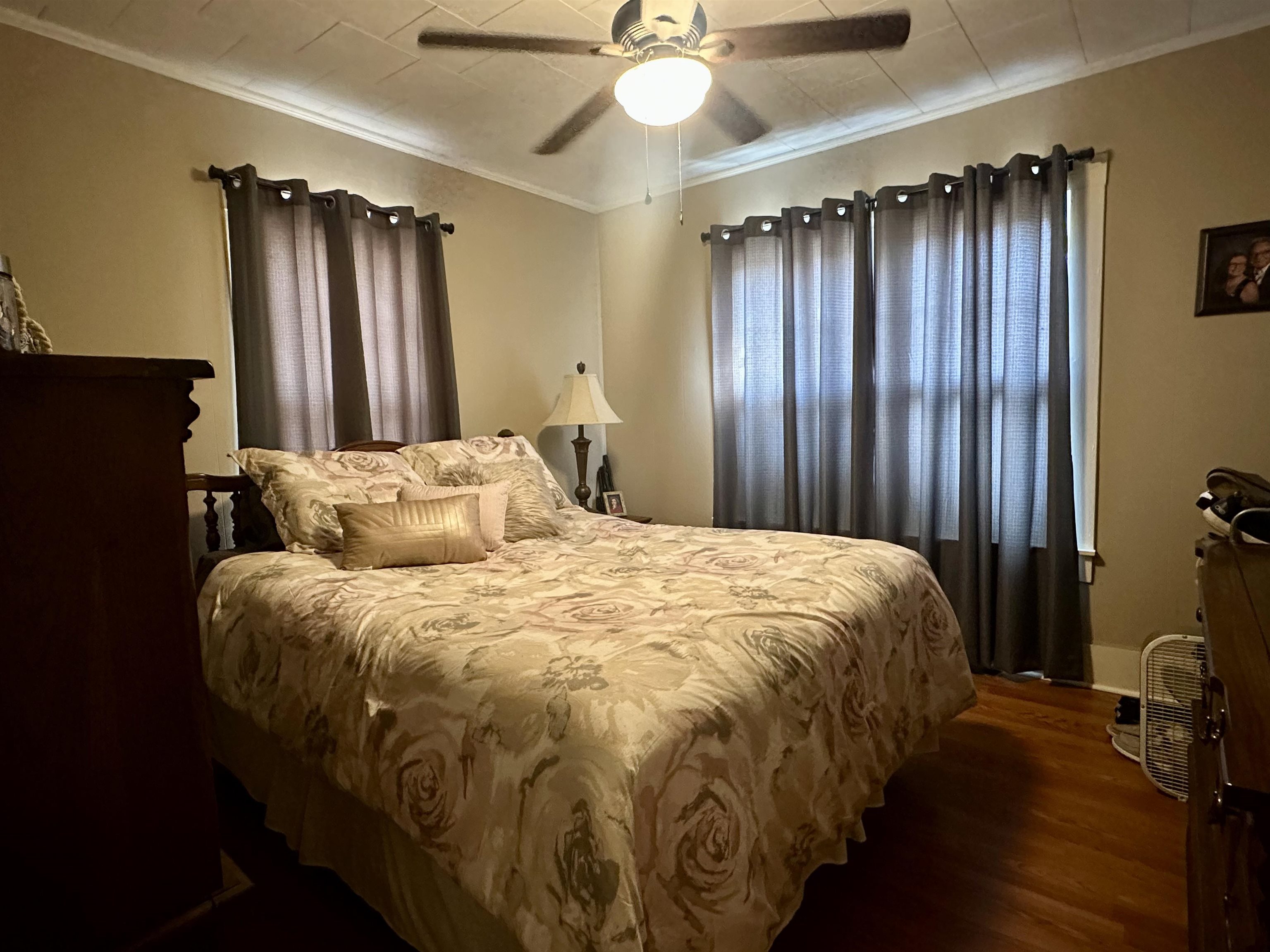 248 Canal Street Selmer, TN 38375 - Photo 11 of 21 a bed sitting in a spacious bedroom next to a window and a chandelier