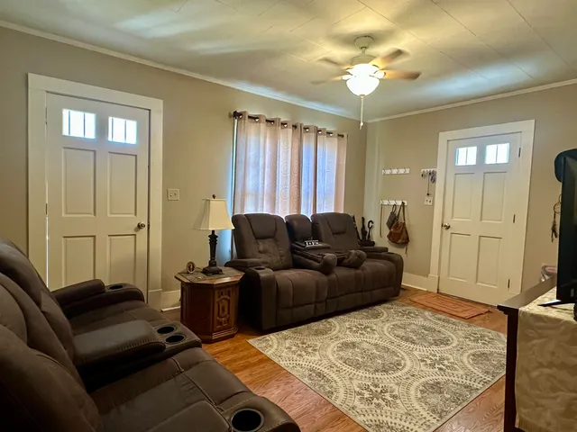 a living room with furniture and a flat screen tv