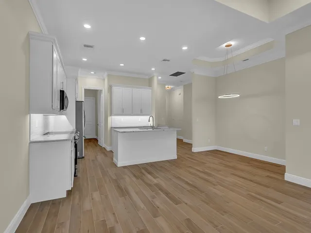 a view of kitchen with wooden floor and electronic appliances