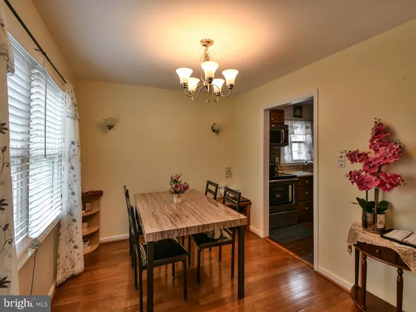 a view of a dining room with furniture wooden floor and chandelier