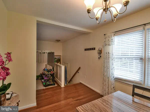 a view of a livingroom with wooden floor and a window