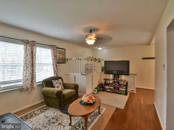 a living room with furniture a flat screen tv and a large window