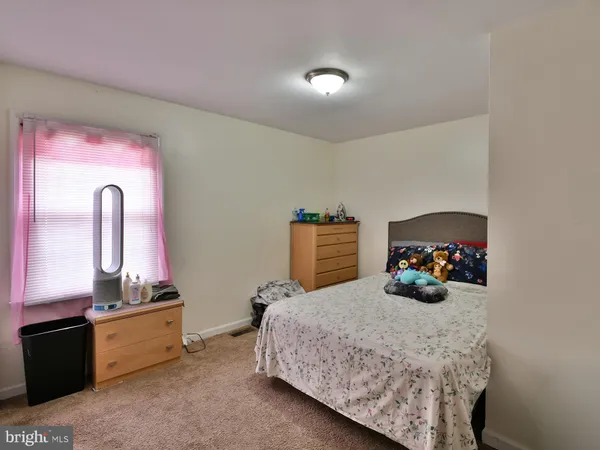 a bedroom with bed and window