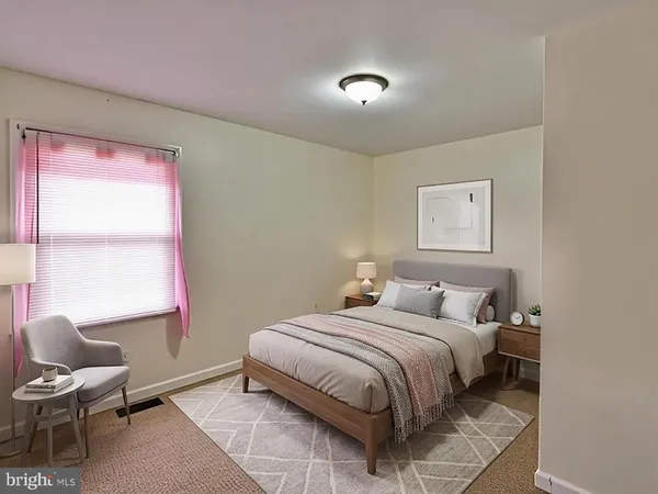 a bedroom with a bed and chair