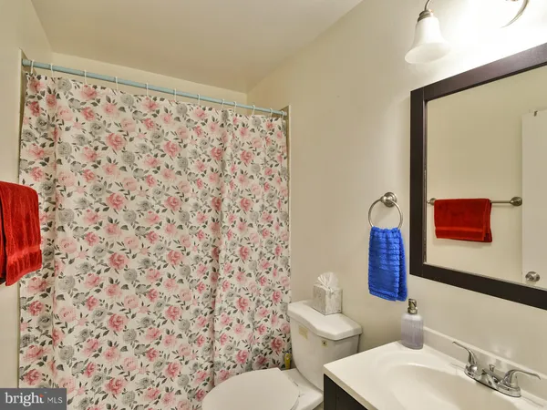 a bathroom with a toilet and a shower curtain