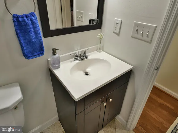 a bathroom with a sink a mirror and a toilet