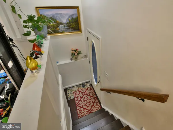 view of a room with painting on the wall and a potted plant