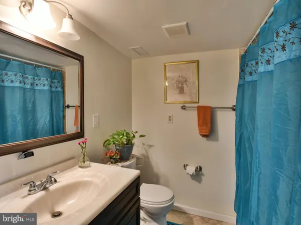a bathroom with a sink toilet and mirror