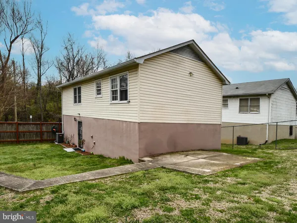 a view of backyard of house with green space