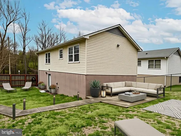 a backyard of a house with fire pit and couches