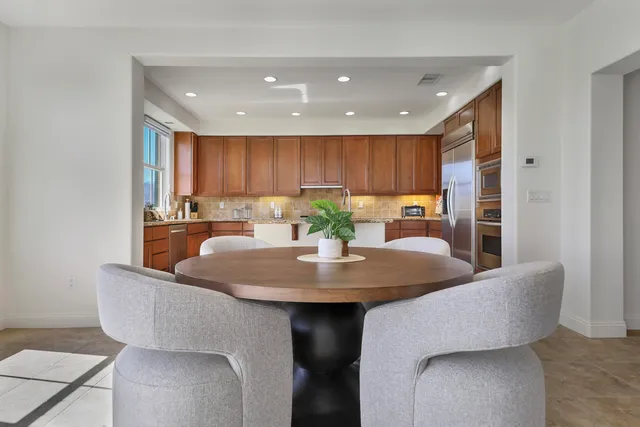 a dining room with furniture and a kitchen view