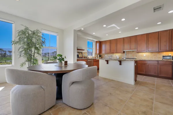a living room with kitchen island furniture and a large window