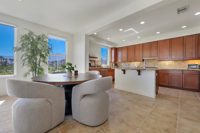 a living room with kitchen island furniture and a large window