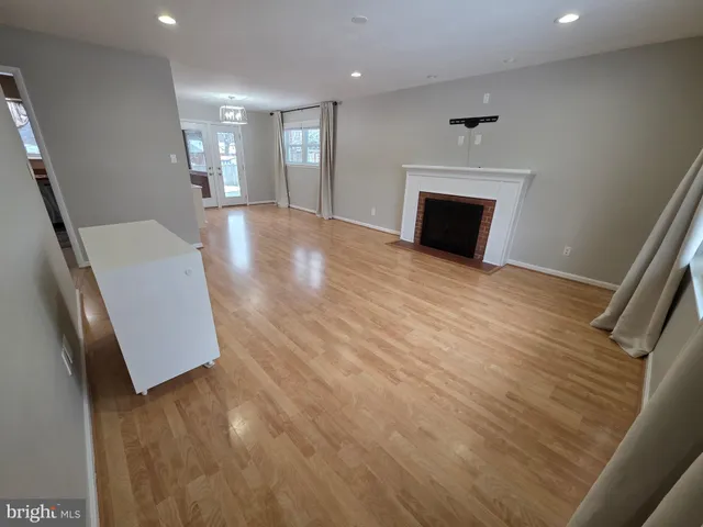 a view of empty room with window and ceiling fan