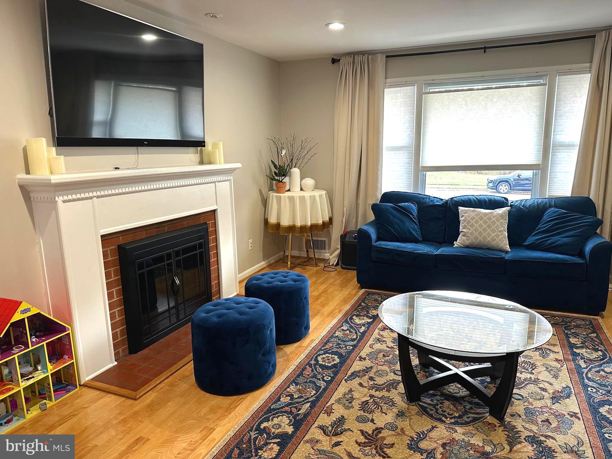 8140 Drayton Lane Springfield, VA 22151 - Photo 13 of 98 a living room with furniture a flat screen tv and a fireplace