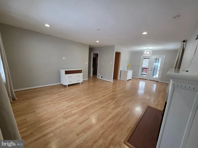 a view of empty room with window and ceiling fan