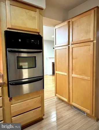 a view of empty room with window and ceiling fan