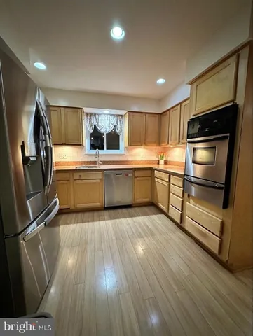a view of a room with wooden floor and fan