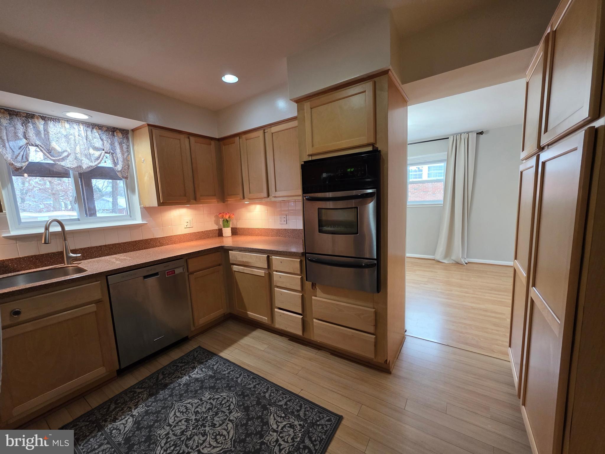 8140 Drayton Lane Springfield, VA 22151 - Photo 32 of 98 a kitchen with stainless steel appliances kitchen island granite countertop a refrigerator and a sink