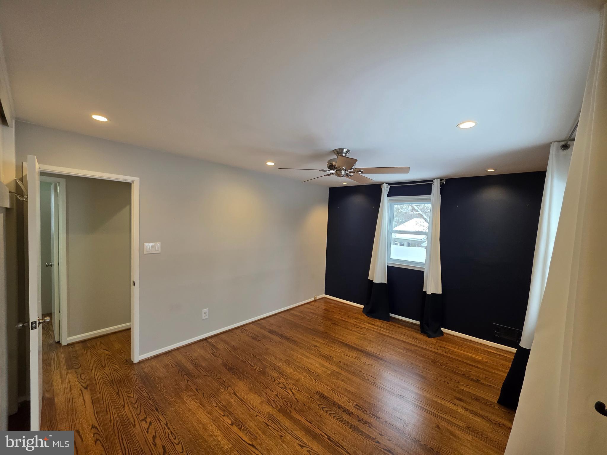 8140 Drayton Lane Springfield, VA 22151 - Photo 41 of 98 a view of empty room with window and wooden floor