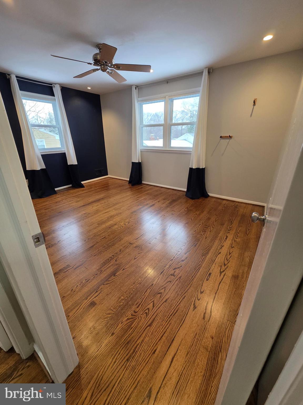8140 Drayton Lane Springfield, VA 22151 - Photo 43 of 98 a view of empty room with wooden floor and fan