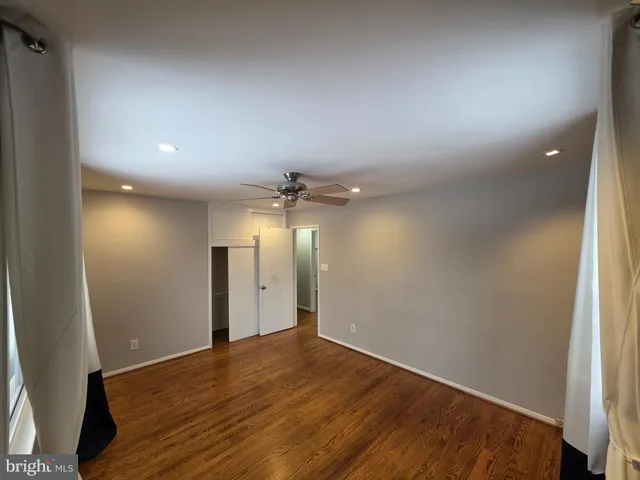 an empty room with windows and closet
