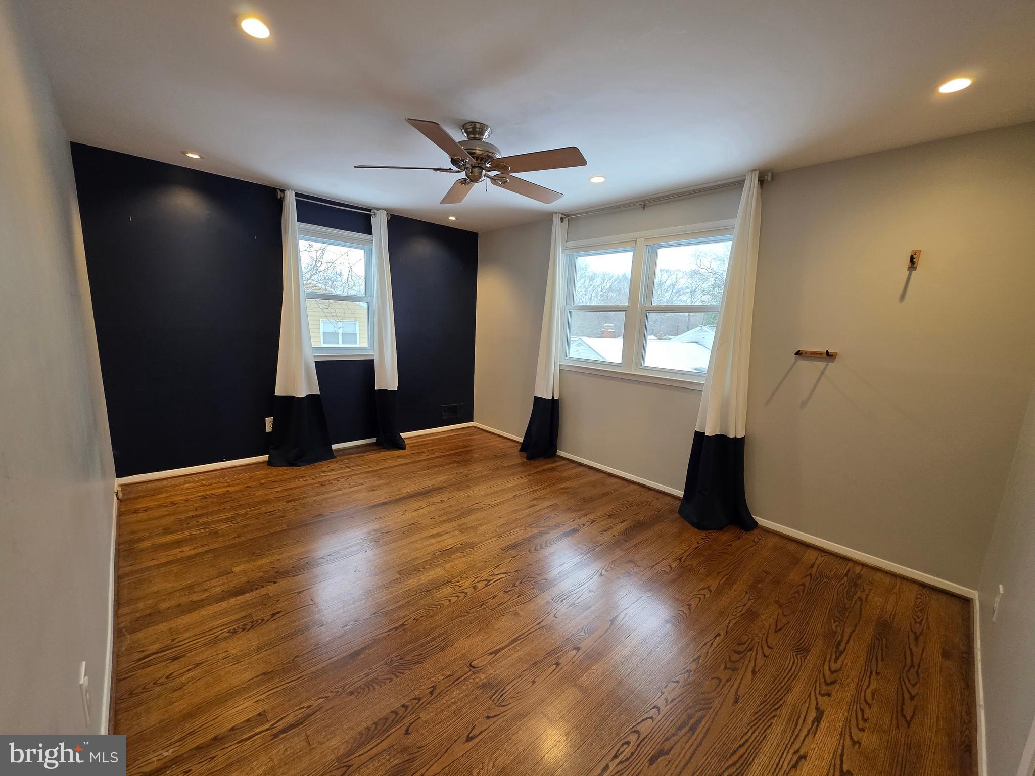 8140 Drayton Lane Springfield, VA 22151 - Photo 46 of 98 a view of empty room with wooden floor and fan