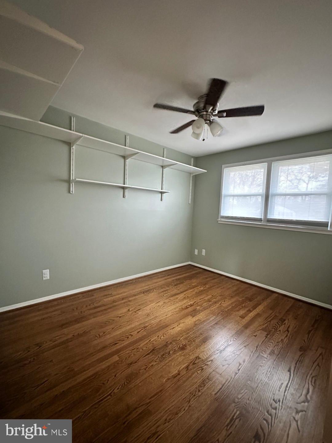 8140 Drayton Lane Springfield, VA 22151 - Photo 51 of 98 a view of an empty room with a window and wooden floor
