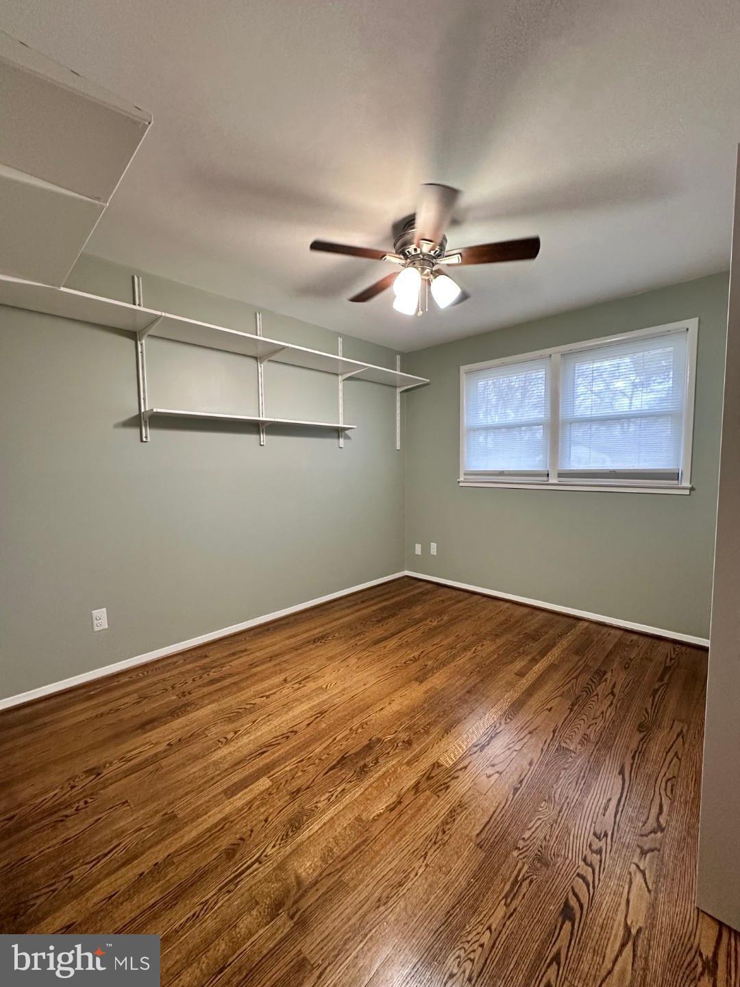 8140 Drayton Lane Springfield, VA 22151 - Photo 57 of 98 an empty room with wooden floor chandelier fan and windows