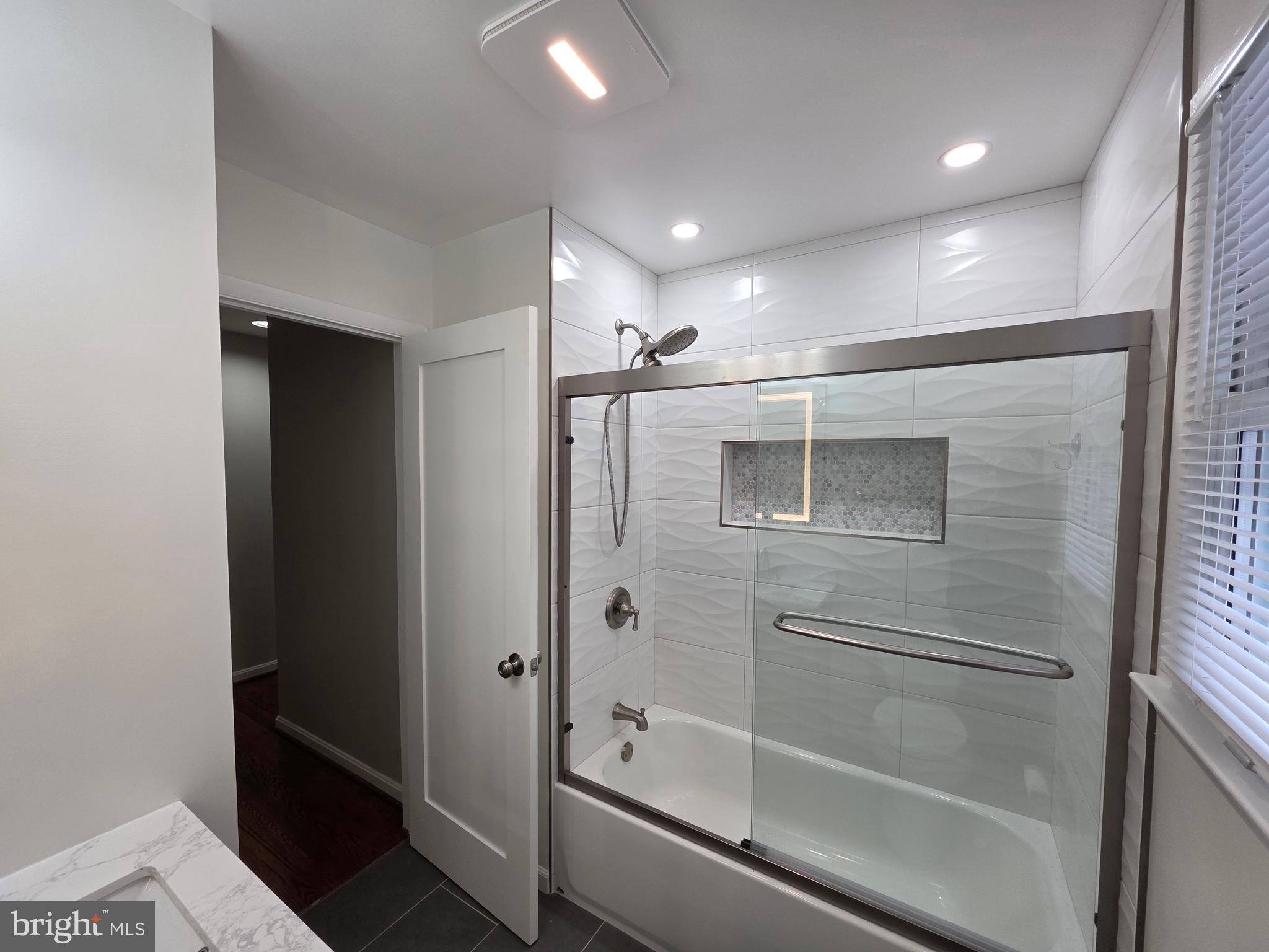 8140 Drayton Lane Springfield, VA 22151 - Photo 69 of 98 a bathroom with a bathtub and a shower