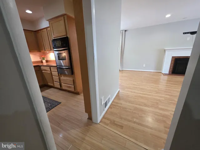a kitchen with stainless steel appliances kitchen island granite countertop a refrigerator and a sink