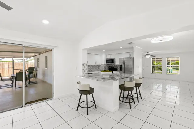 a living room with furniture a flat screen tv and view