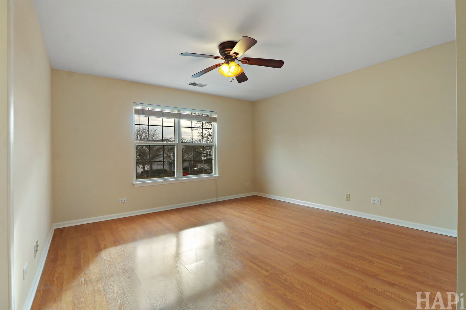 1728 Leeds Court, Unit 1728 Mundelein, IL 60060 - Photo 12 of 23 a view of an empty room with wooden floor and a window