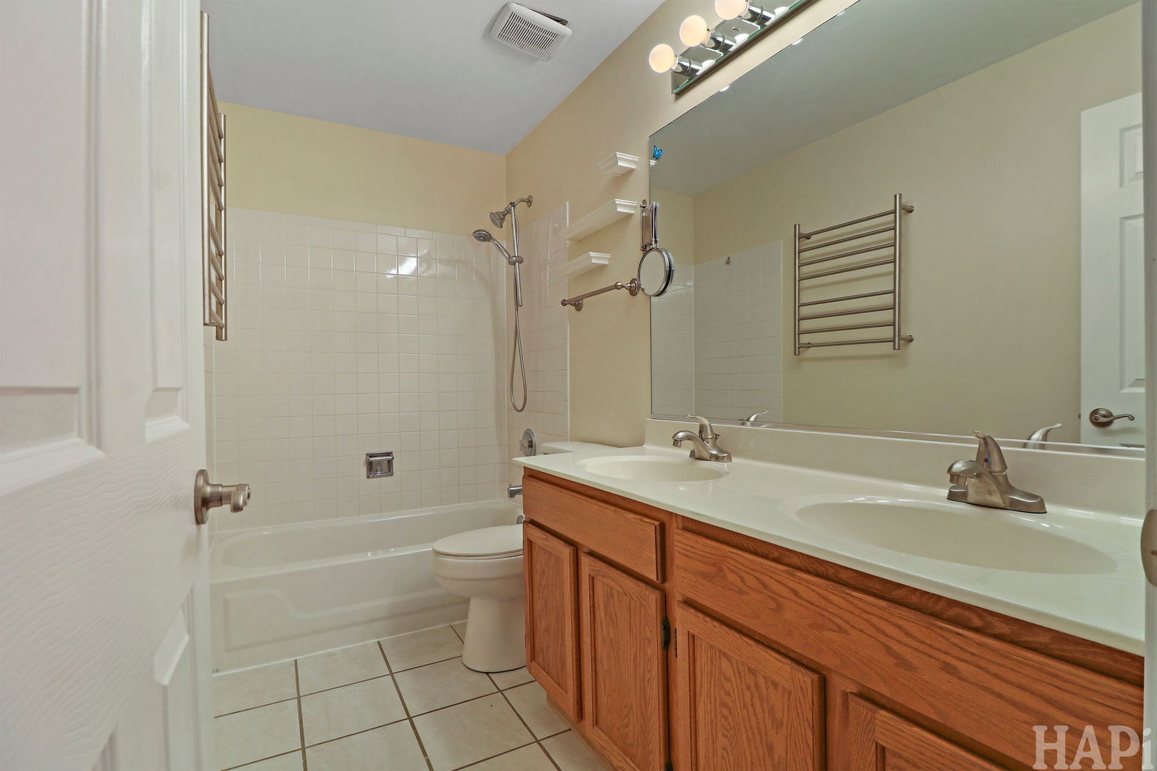 1728 Leeds Court, Unit 1728 Mundelein, IL 60060 - Photo 14 of 23 a bathroom with a granite countertop sink a toilet a mirror and shower