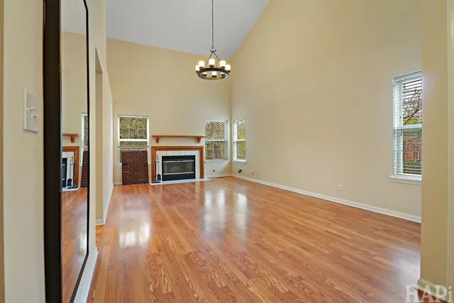 a view of a livingroom with wooden floor and a ceiling fan