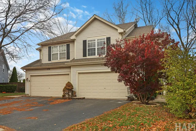 a view of a house with a yard and garage