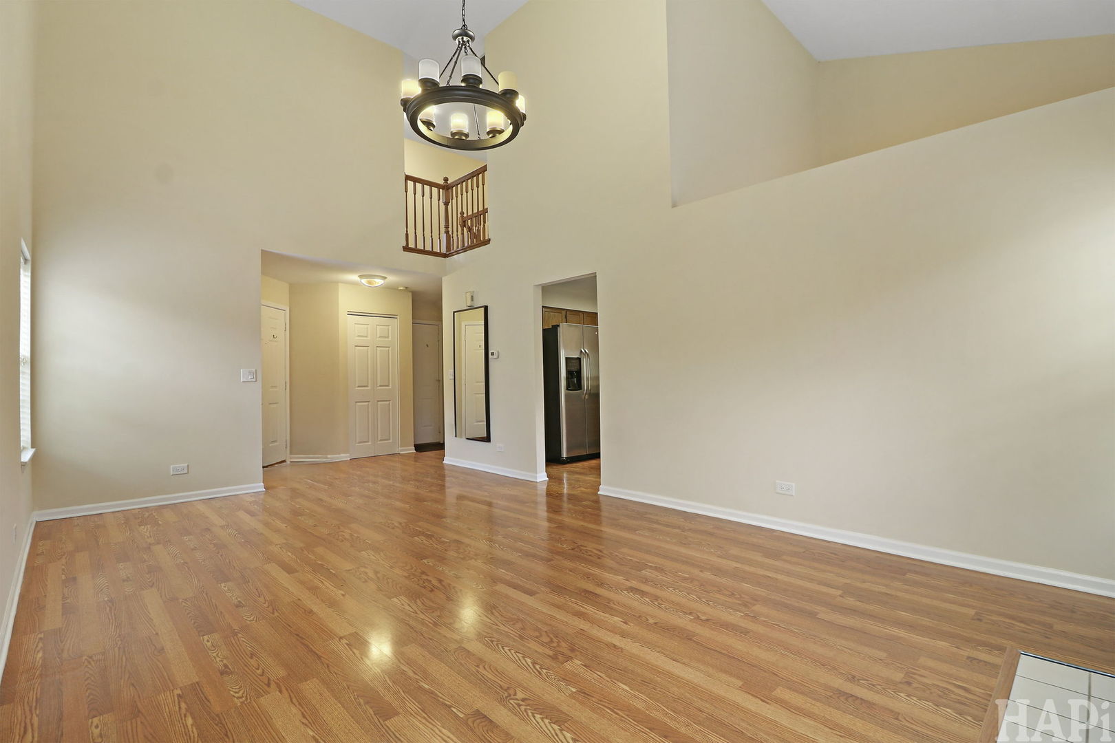 1728 Leeds Court, Unit 1728 Mundelein, IL 60060 - Photo 5 of 23 a view of an empty room with wooden floor and a window