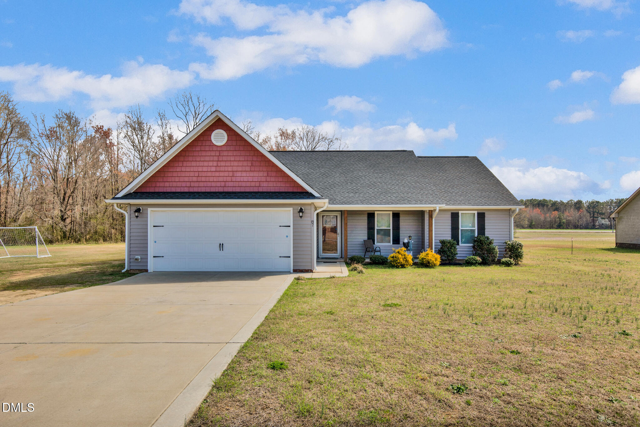 a front view of a house with yard and porch