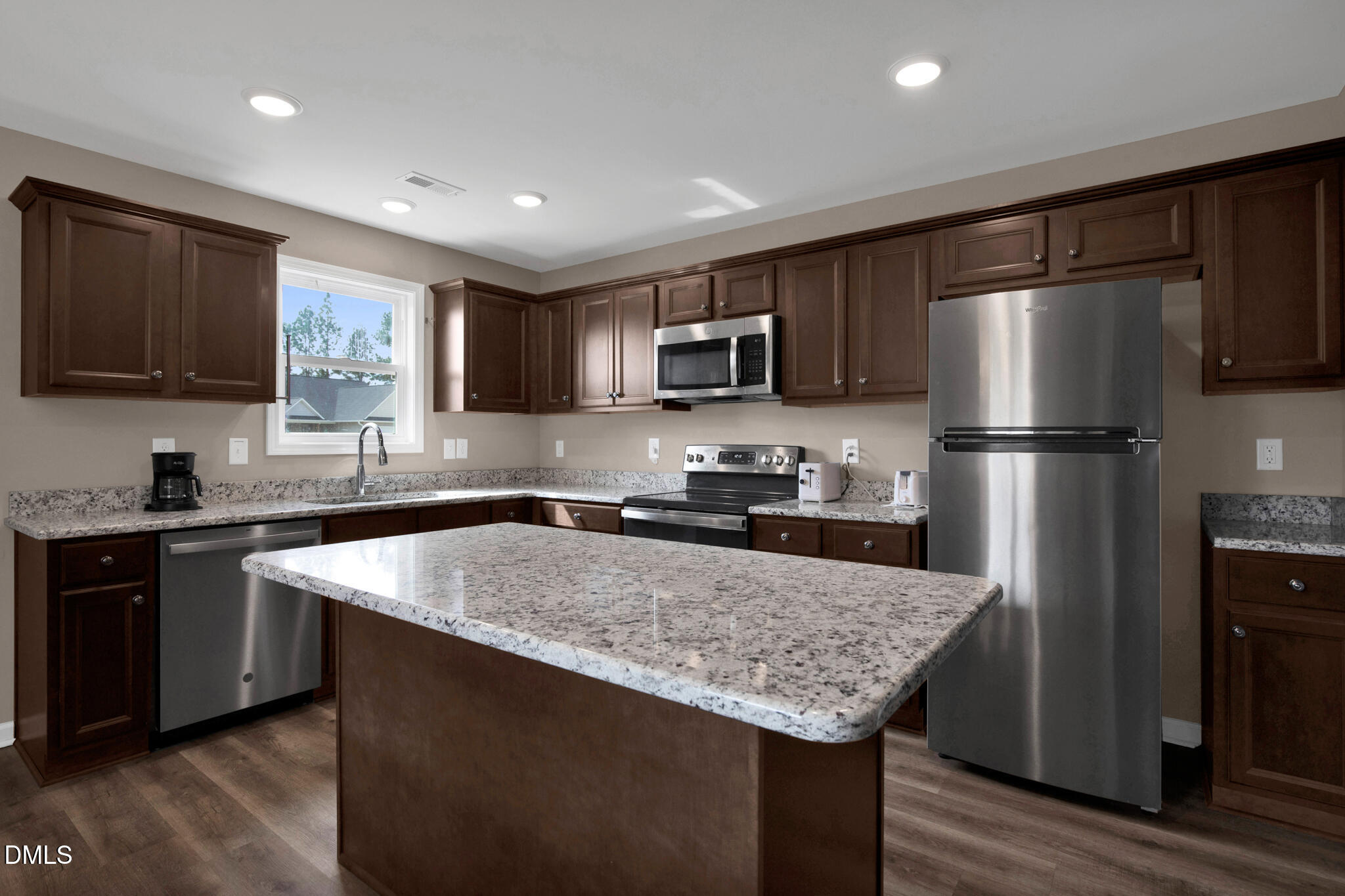 87 Hawks Croft Court Erwin, NC 28339 - Photo 11 of 30 a kitchen with a refrigerator a microwave a sink and cabinets