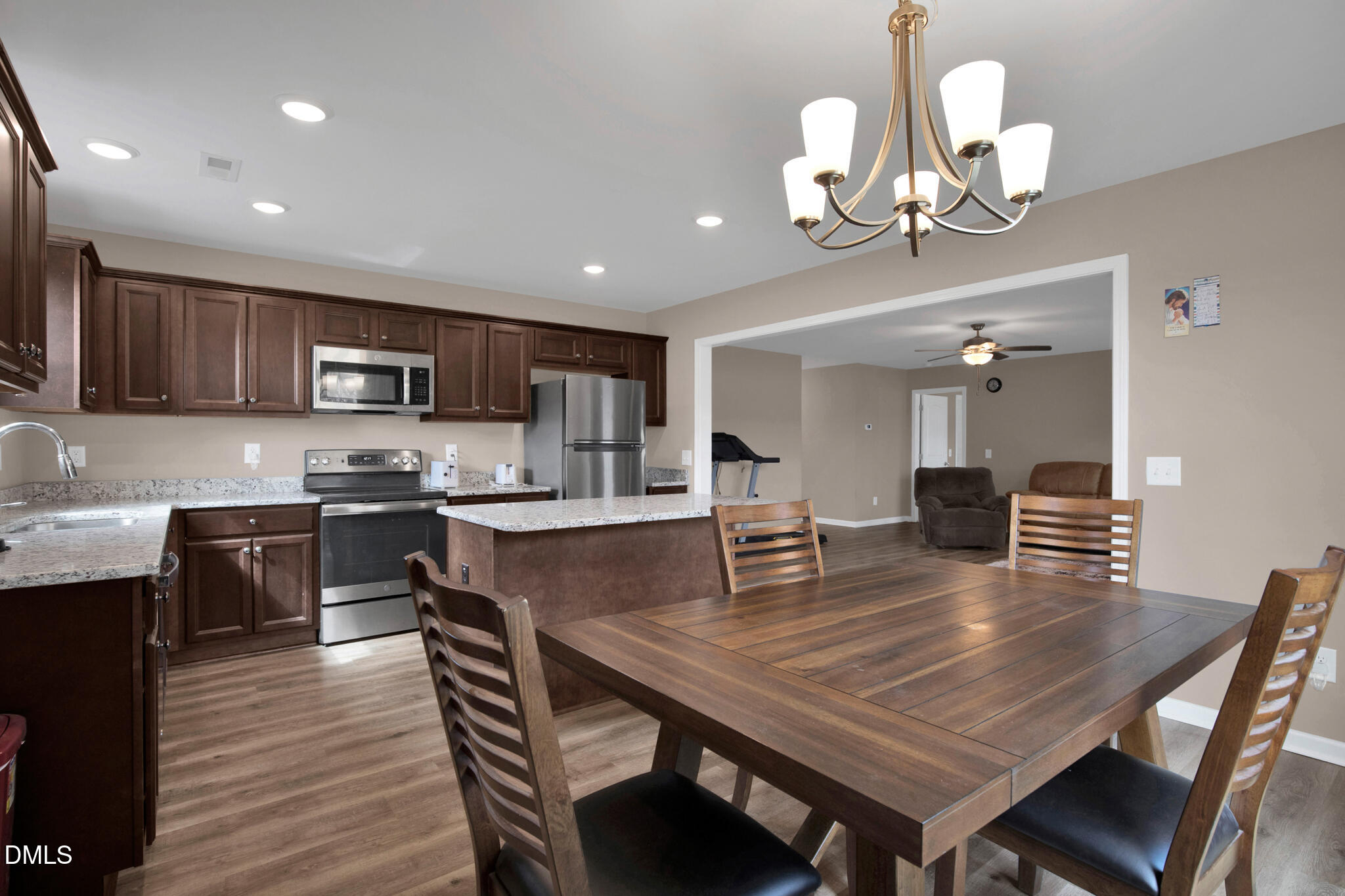 87 Hawks Croft Court Erwin, NC 28339 - Photo 15 of 30 a kitchen with a dining table chairs stainless steel appliances and cabinets