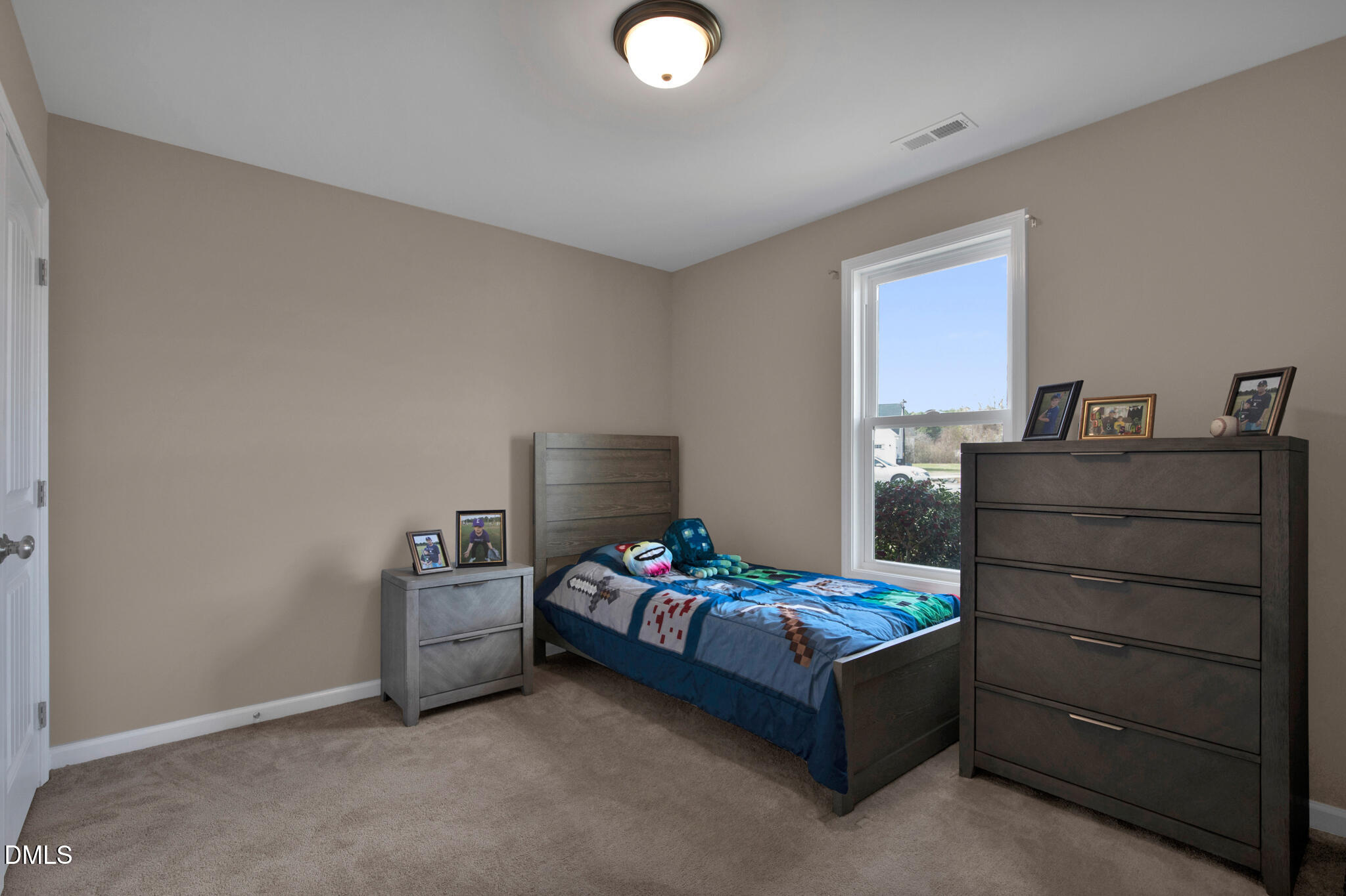 87 Hawks Croft Court Erwin, NC 28339 - Photo 22 of 30 a bedroom with a bed and a chandelier