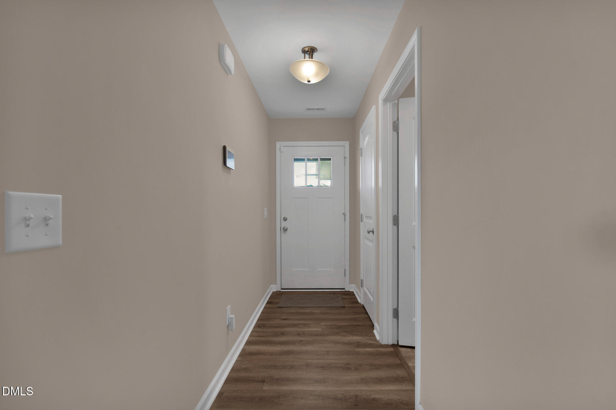 87 Hawks Croft Court Erwin, NC 28339 - Photo 5 of 30 a view of a hallway with wooden floor and a chandelier