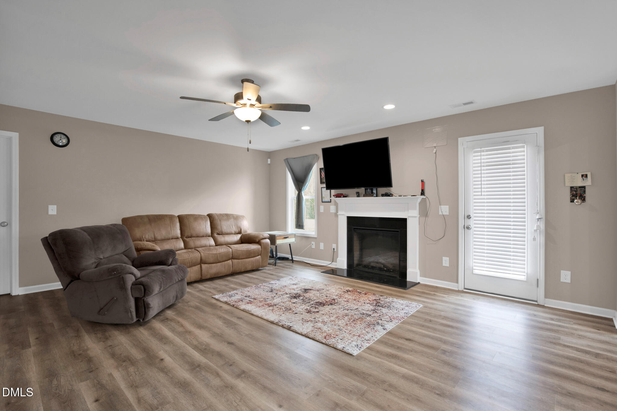 87 Hawks Croft Court Erwin, NC 28339 - Photo 7 of 30 a living room with furniture a fireplace and a flat screen tv