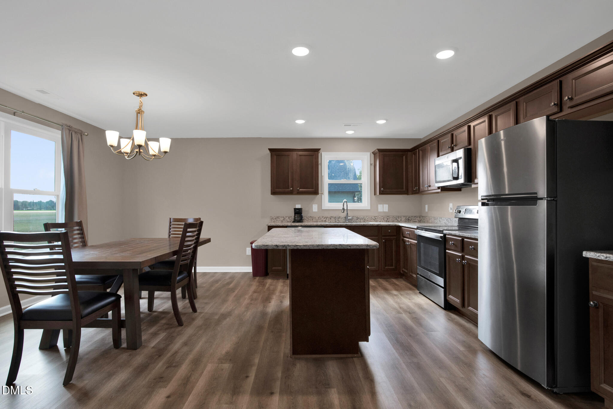 87 Hawks Croft Court Erwin, NC 28339 - Photo 10 of 30 a kitchen with stainless steel appliances granite countertop a refrigerator a stove top oven a sink dishwasher a dining table and chairs with wooden floor