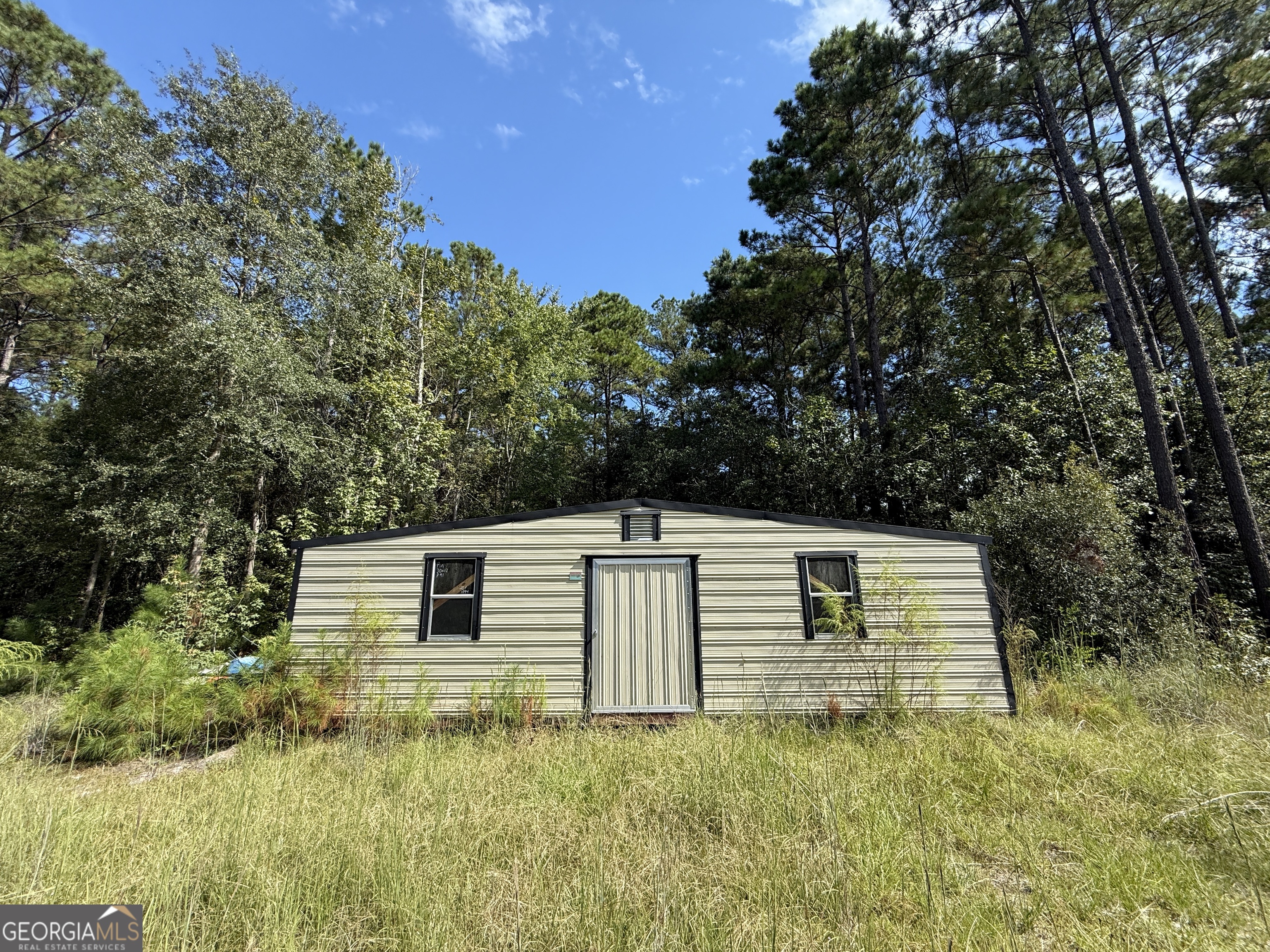124 Oak Street Rincon, GA 31326 - Photo 10 of 10 a backyard of a house with lots of green space