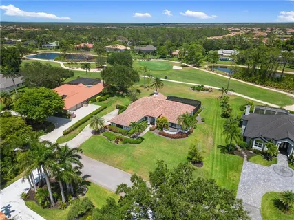an aerial view of a houses with a yard