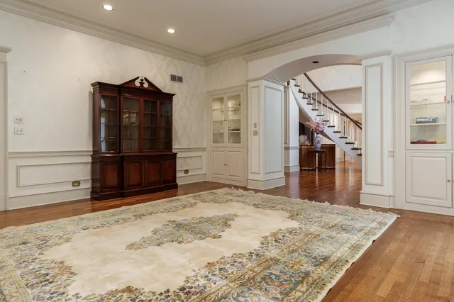 an empty room with windows and fireplace