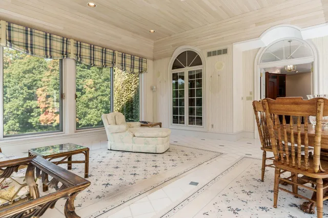 a large kitchen with stainless steel appliances a large counter top and a refrigerator